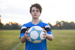 © Austockphoto - Teenage soccer player on a soccer pitch with ball