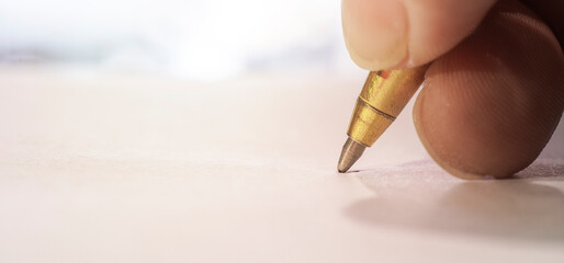 selective focus, pen write signature on white paper. contract signature agreement.