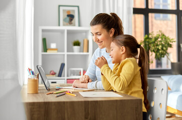 Sticker - family, motherhood and leisure concept - mother spending time with her little daughter drawing with color pencils and using tablet pc computer at home