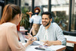 © Drazen - Happy man talking to his girlfriend while sitting at reopened cafe during coronavirus pandemic.