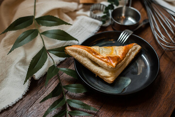 tuna pie with ceramic plate on a wooden table