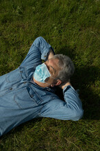 Elderly Man Lying On The Grass With Mask!