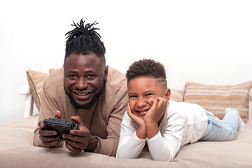 Wall Mural - Waist up portrait of dark skinned  male and his little son spending time together, isolated