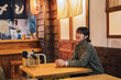 © ADDICTIVE STOCK - Joyful Asian lady in cozy cafe