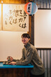 © ADDICTIVE STOCK - Joyful Asian woman in modern cafe