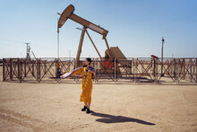 Woman Standing On Oil Field