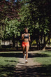 © ADDICTIVE STOCK - Young fitness African American woman running on park
