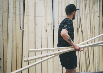 a man in a hardware store buys construction materials wood