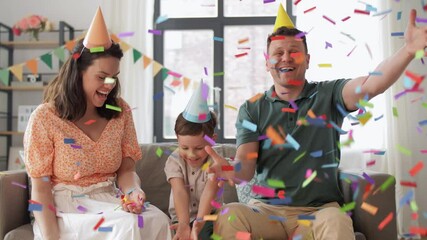 Wall Mural - family, holidays and people concept - happy mother, father and little son in party caps having fun and celebrating birthday at home