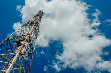 Wall Mural - metal tower for mobile radio communication on a background of blue sky