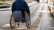 © Vergani Fotografia - detail of backpack in wheelchair ascending ramp to train station.