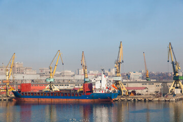 Seaport with cranes and moored dry cargo ship in Constanta Romania. Shipyard in Romania.