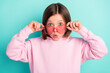 Photo of brunette hairdo impressed little girl hold eyewear wear pink sportswear isolated on teal color background