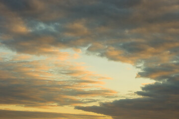 Wall Mural - Landscape with dramatic light - beautiful golden sunset with saturated sky and clouds.