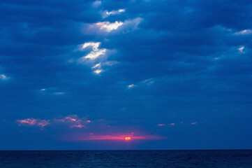 Wall Mural - Amazing sea sunset, the sun, waves, clouds