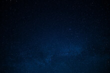 Night Starry Sky. Deep Saturated Dark Blue Color. Small Stars Twinkle Far Away In The Sky. There Is No One In The Photo. There Is A Place For Your Signature. Background. Wallpaper. Texture.