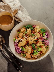 Broccoli salad with dressing on dining table