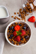 Granola with and berries for healthy breakfast. Top view. Bowl of granola with strawberry and blueberries, served with milk