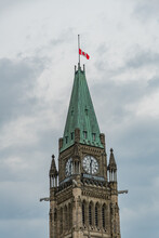 Parliament In Ottawa Clock Tower With Flag At Half Mast