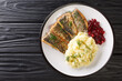 Fried herring fillets with mashed potatoes and lingonberry sauce close-up in a plate on the table. horizontal top view from above