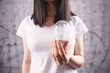 © Artvibe - young woman holding a light bulb