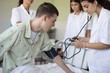 © liderina - Young student in hospital measures the patient's pressure.