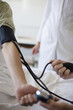 © liderina - The doctor measures the patient's pressure with a stethoscope. Close up. Focus is on hands.