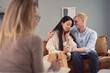 © ADDICTIVE STOCK - Happy multiethnic couple embracing during psychotherapy session