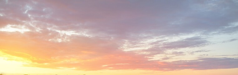 Wall Mural - Clear blue sky. glowing pink, golden cirrus and cumulus clouds after storm, soft sunlight. Sunset cloudscape. Meteorology, midnight sun, heaven, peace, graphic resources, picturesque panoramic scenery