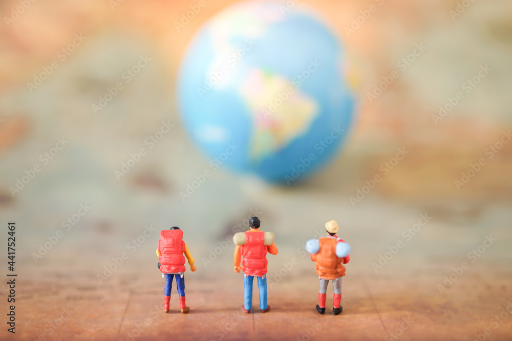 Miniature people: A traveler mini figures with backpack standing on ...