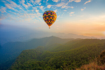 mountains and balloons,Colorful hot air balloons flying over mountain at Dot Inthanon in Chiang Mai, Thailand