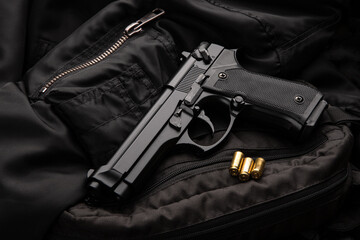 Black modern pistol on a dark back. A short-barreled weapon for concealed carry. Armament of the police, army and special units.