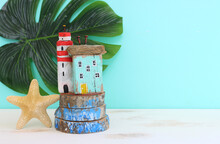 Nautical Concept With Sea Life Style Objects As Driftwood Beach Houses And Starfish Over Wooden Table And Blue Background