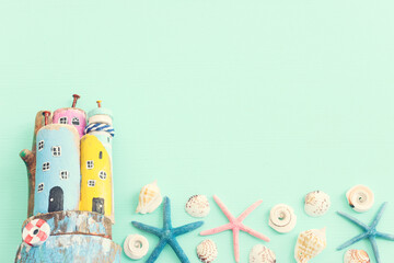 Wall Mural - Top view of Nautical concept with sea life style objects as boat, driftwood beach houses, seashells and starfish over wooden background