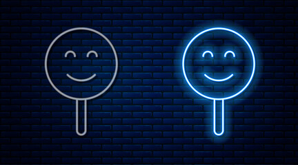 Wall Mural - Glowing neon line Smile face icon isolated on brick wall background. Smiling emoticon. Happy smiley chat symbol. Vector