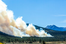 Forest Fire Produces Large Smoke Plume That Is Blown In Lake County Colorado Near Twin Lakes With Mountain Peaks In Backdrop