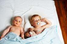 Little Babies, Boy And Girl Lay In A Bed Waking Up