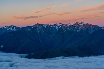 Wall Mural - Low Clouds And High Mountains