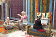 © fatih nebioglu - Woman hands weaving carpet on the loom