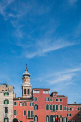 Wall Mural - Venetian houses and tower under blue sky in Venice, Italy