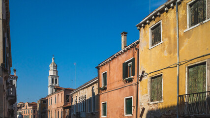 Wall Mural - Venetian houses and tower under blue sky in Venice, Italy