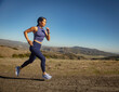 © Tetra Images - Woman jogging in landscape