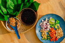 Miang Kham Or Savoury Leaf Wraps Is Popular Thailand Traditional Snack Food, On Wooden Background