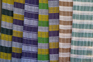 Wall Mural - Handmade colorful Burmese fabric for sell in a tourist stall on the street market near Inle Lake in Burma, Myanmar