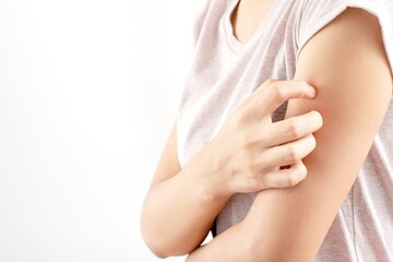 Woman itchy arm due to allergy to skin lotion.