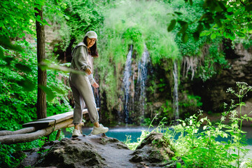 Poster - woman hiker enjoying view of waterfall