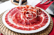 Plate of acorn-fed Iberian ham on the table at an event
