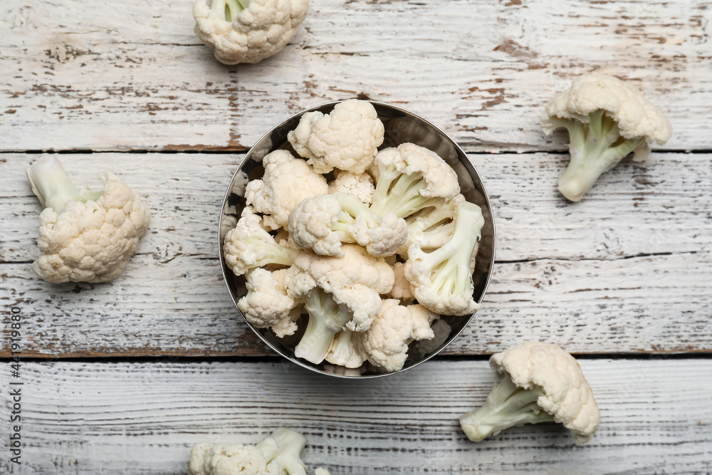 Bowl with cauliflower cabbage on wooden background