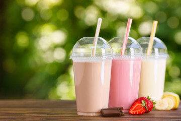 Poster - set of different milkshakes in disposable plastic glasses