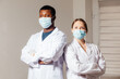 © oksix - Diverse male and female doctors in white medical masks